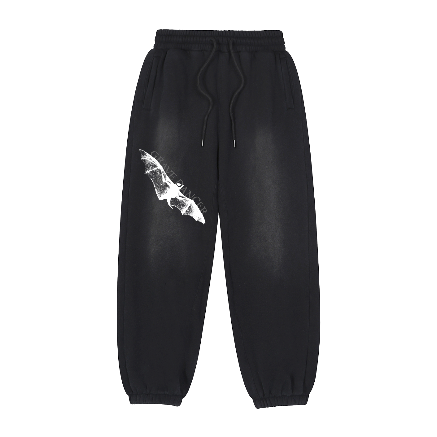 Washed black unisex sweatpants feature a white graphic of a bat wing and the text "GRAVE DANCER" on the left thigh. They have an elasticated waistband with drawstrings and elasticated cuffs.