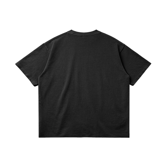 Back view of a black heavyweight cotton t-shirt highlighting the drop-shoulder construction and clean, boxy streetwear silhouette.