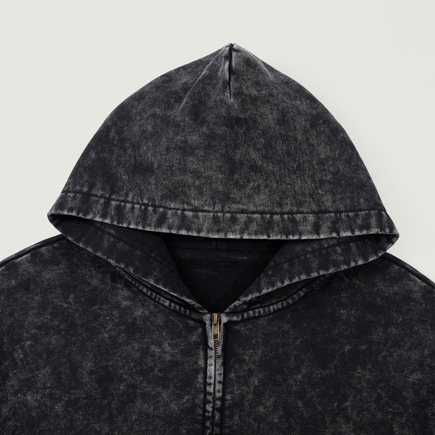 Close-up of black snow-wash hood and zipper area showing washed vintage texture.
