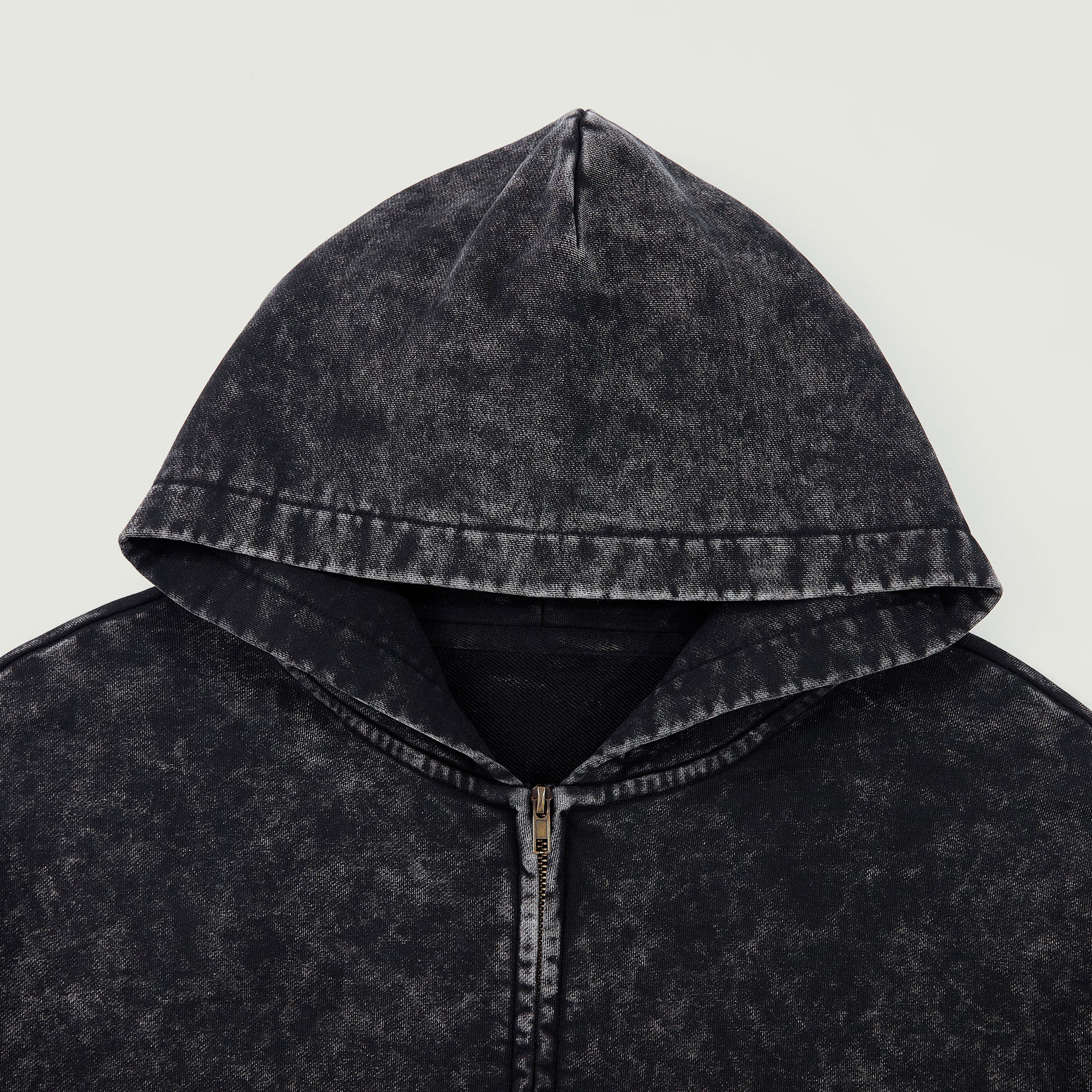 Close-up of black snow-wash hood and zipper area showing washed vintage texture.