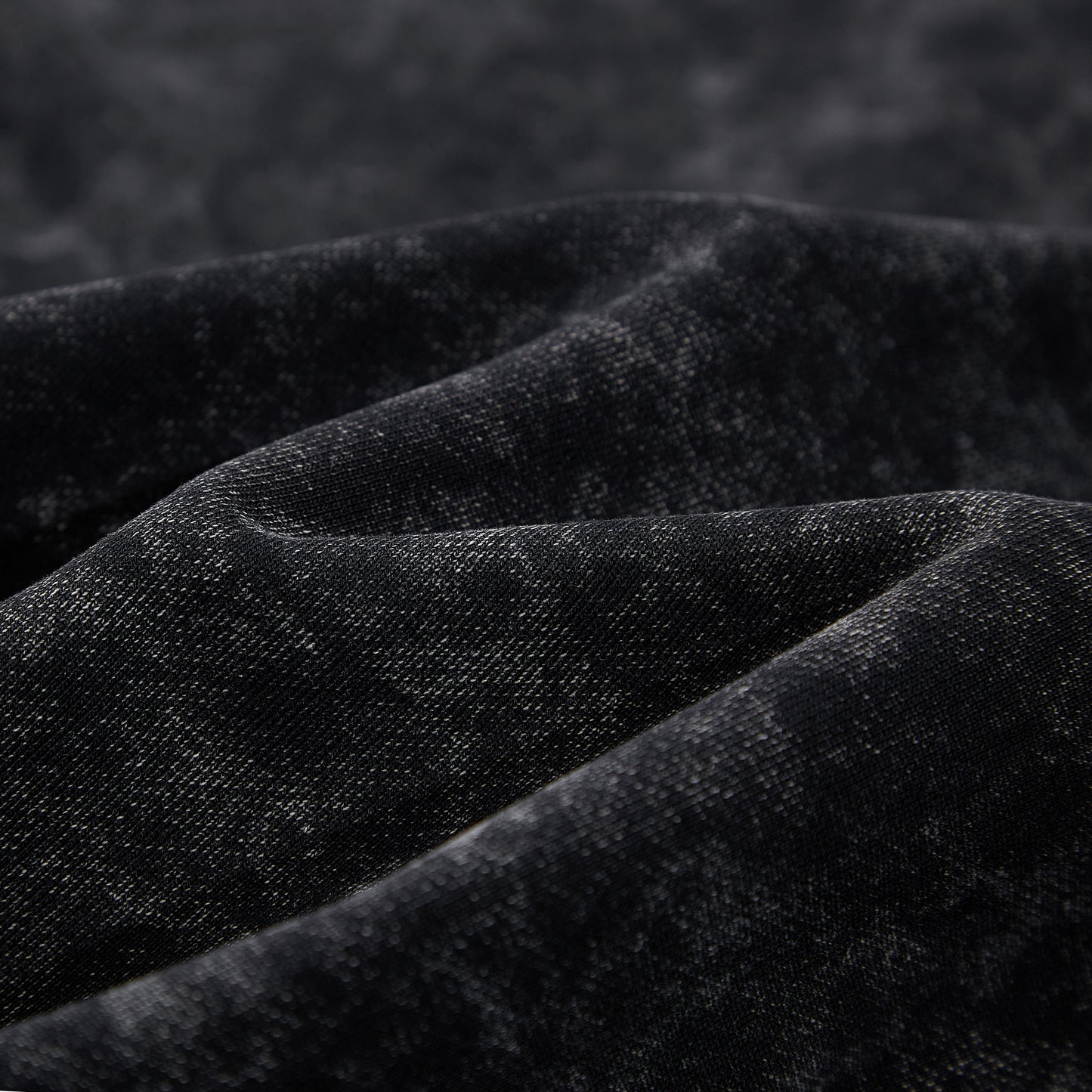 Close-up of black cotton fleece interior texture on SXDGXDS hoodie.