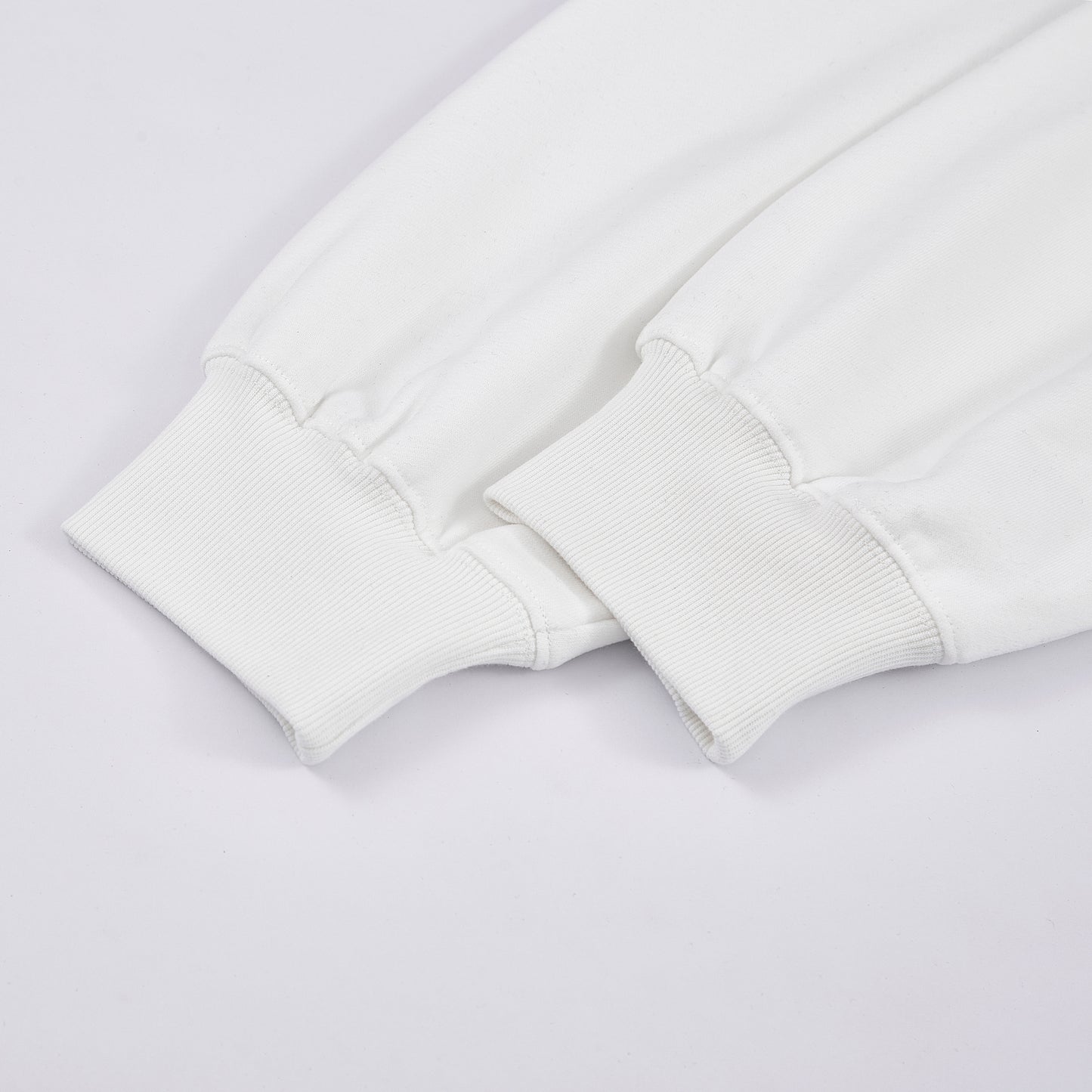 Close-up of a white sweatshirt on a light gray background