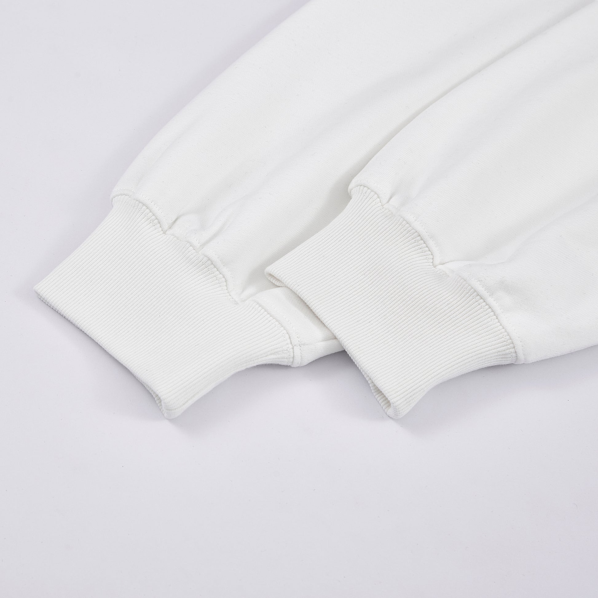 Close-up of a white sweatshirt on a light gray background