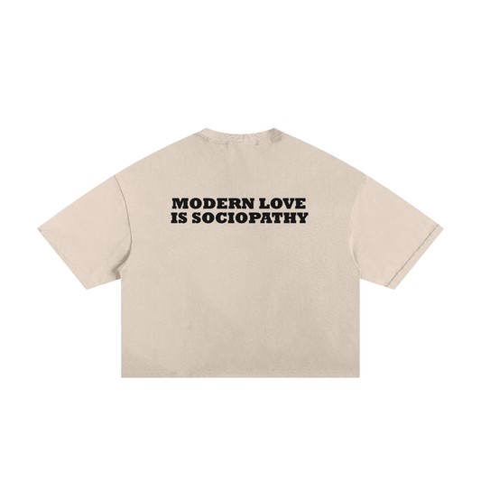 The back of a beige T-Shirt with the text "Modern love is sociopathy"