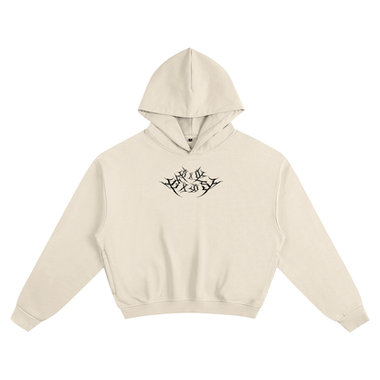 A beige Hoodie with a black metal logo in the middle spelling "SXDGXDS"