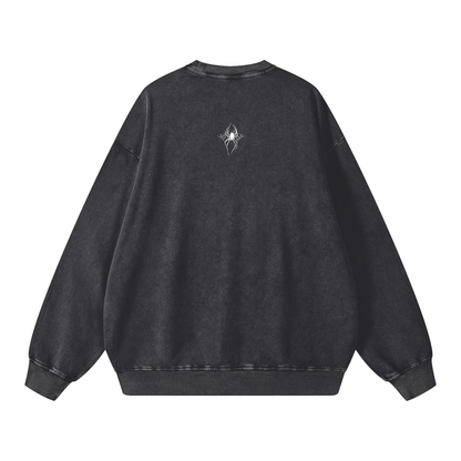 Back view of a black washed sweatshirt, featuring a small white spider graphic positioned above a stylized metal logo that reads "SXDGXDS" at the upper back.
