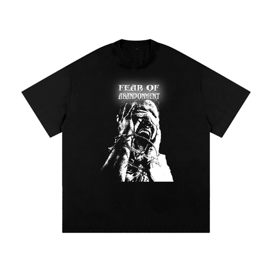 Black T-Shirt, with "FEAR OF ABANDONMENT" text in distressed font above a monochrome graphic of a distressed person with hands over their face, fingers appearing bound