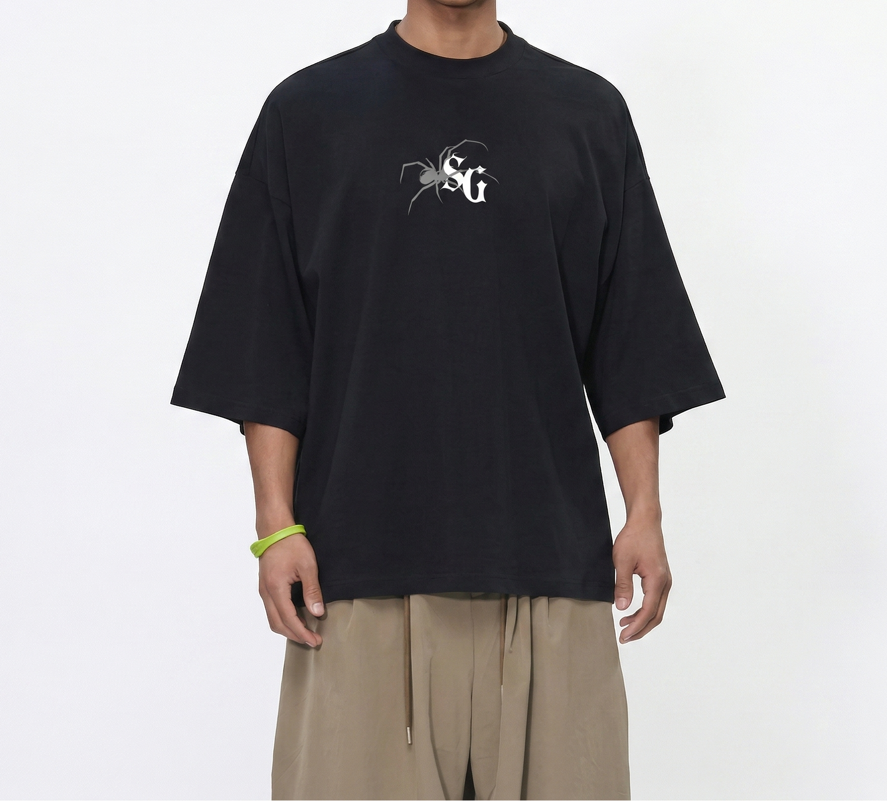 Person wearing a black t-shirt with a logo on a white background