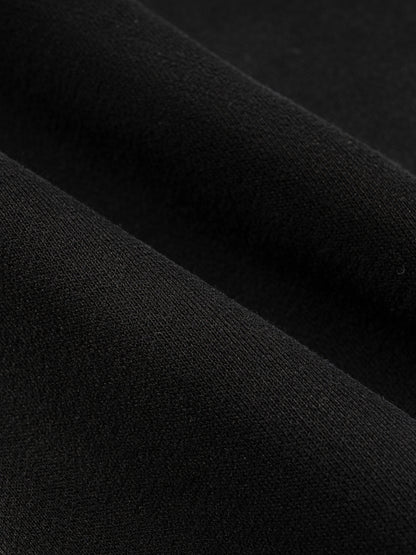Close-up of black cotton-blend fabric texture on SXDGXDS hoodie.