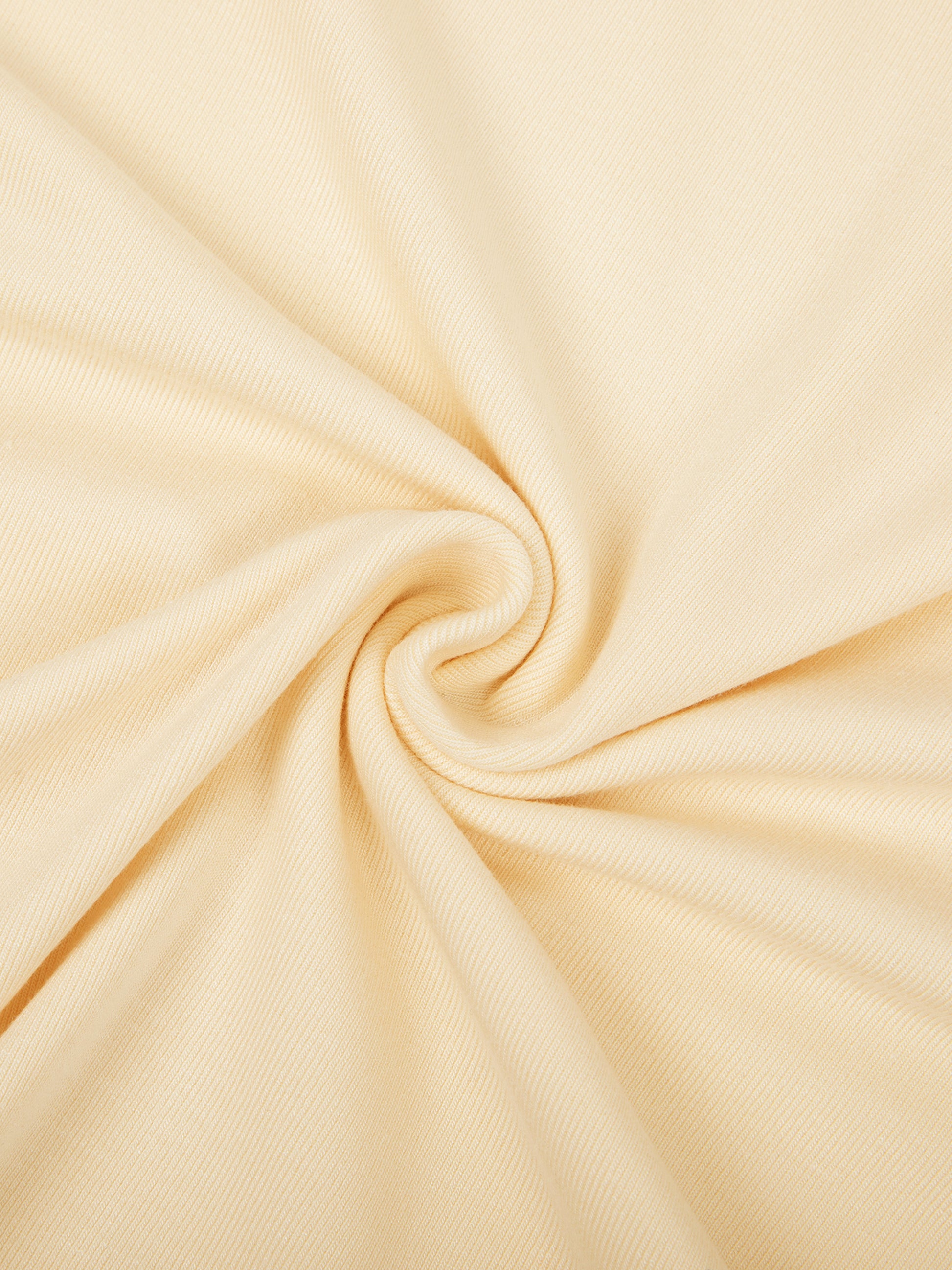 Close-up of beige fabric with a swirl pattern