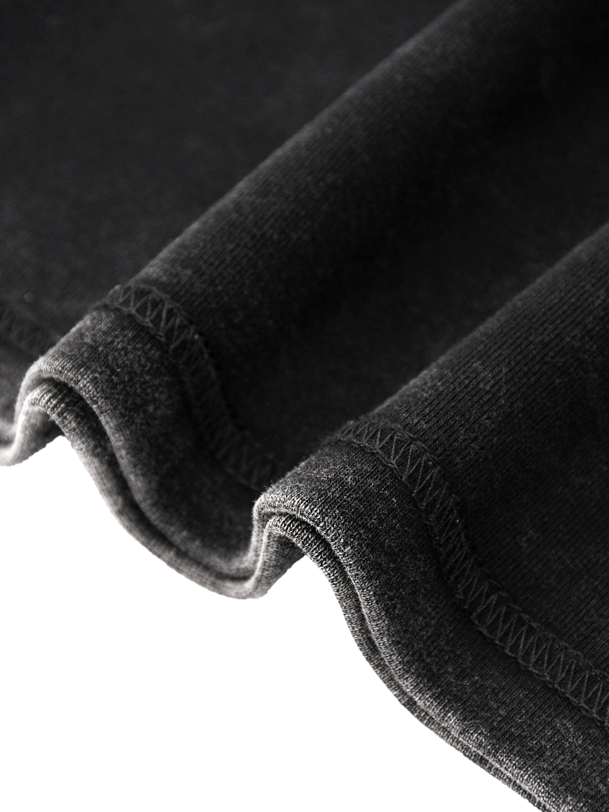 Close-up of black fabric with a textured surface on a dark background