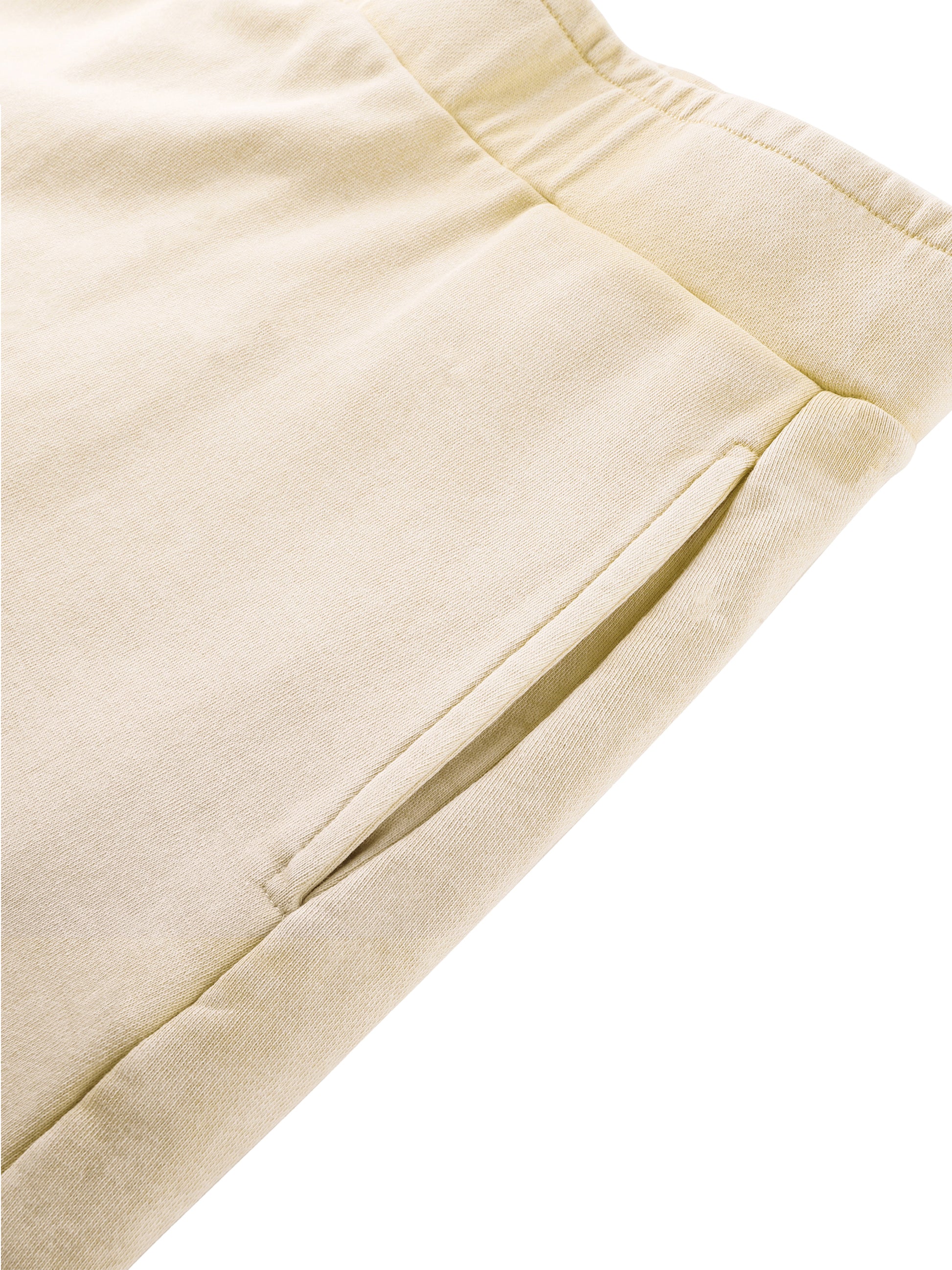 Close-up of beige pants with a white background