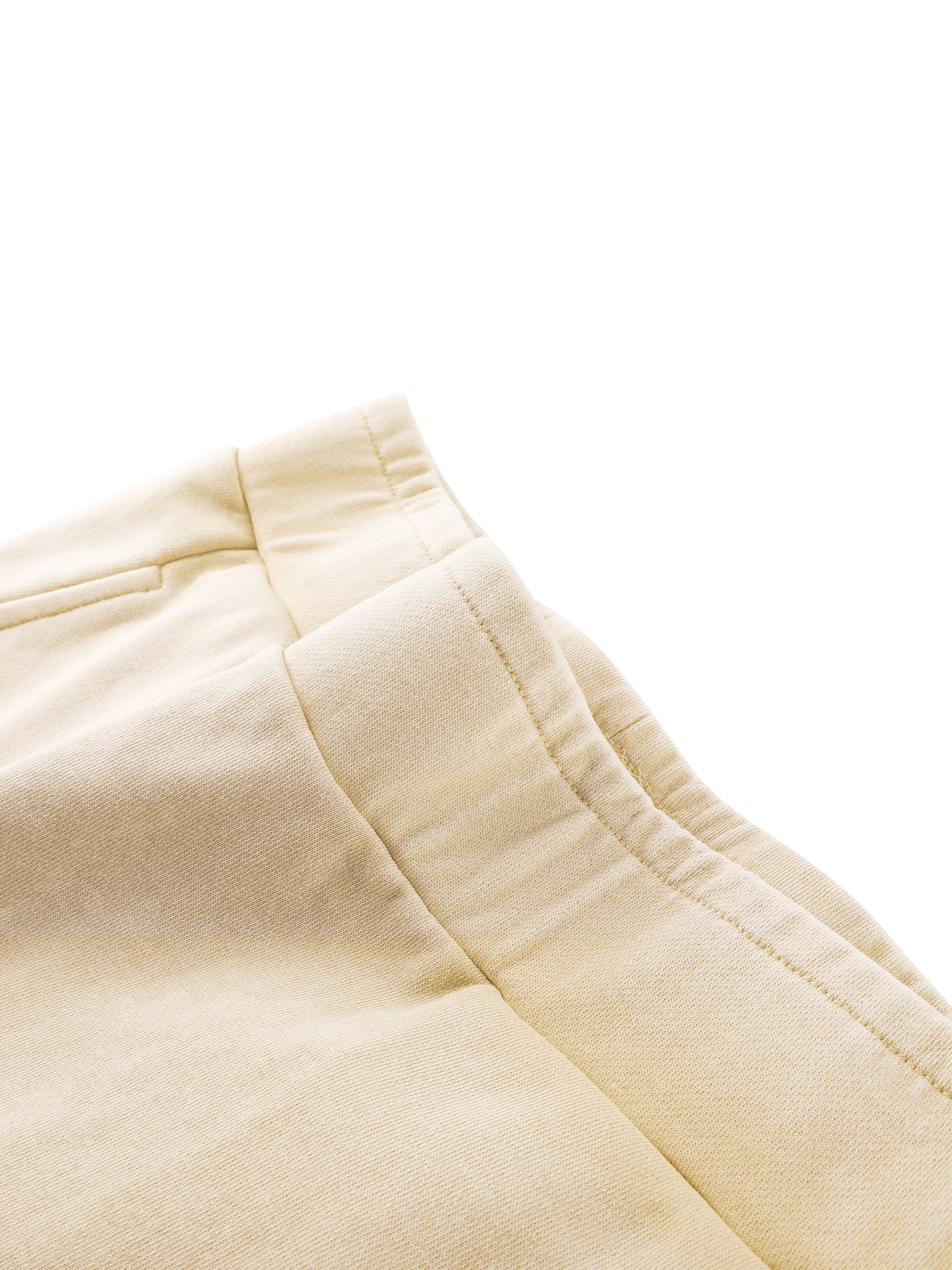 Close-up of beige pants on a white background