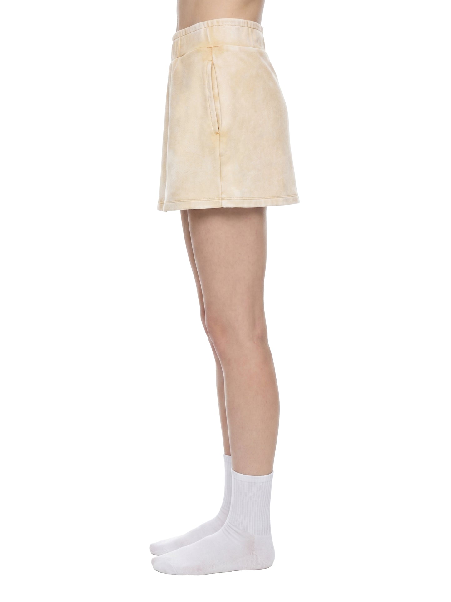 Beige skirt worn by a person on a white background